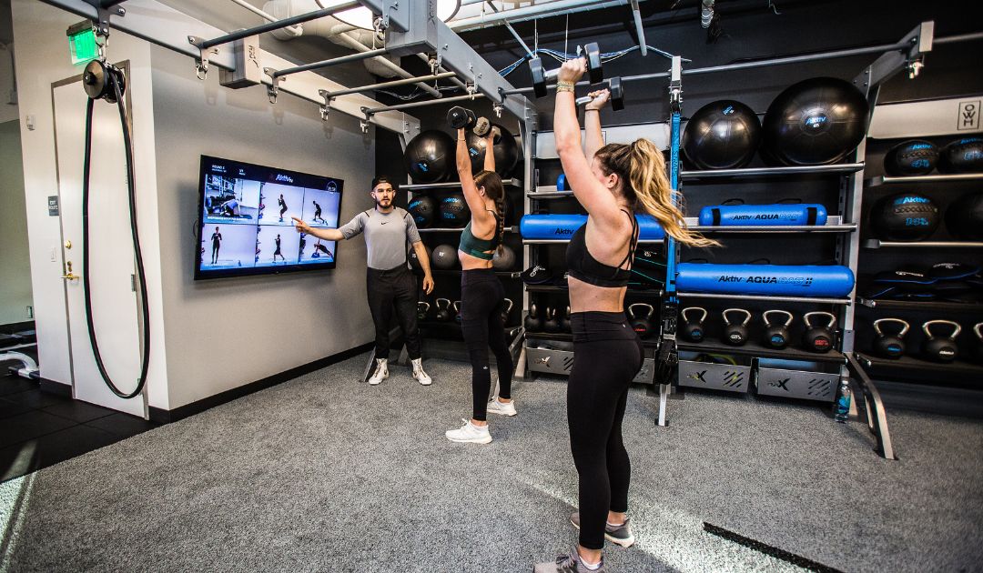 Community recreation fitness center overall gym design with digital fitness offering.