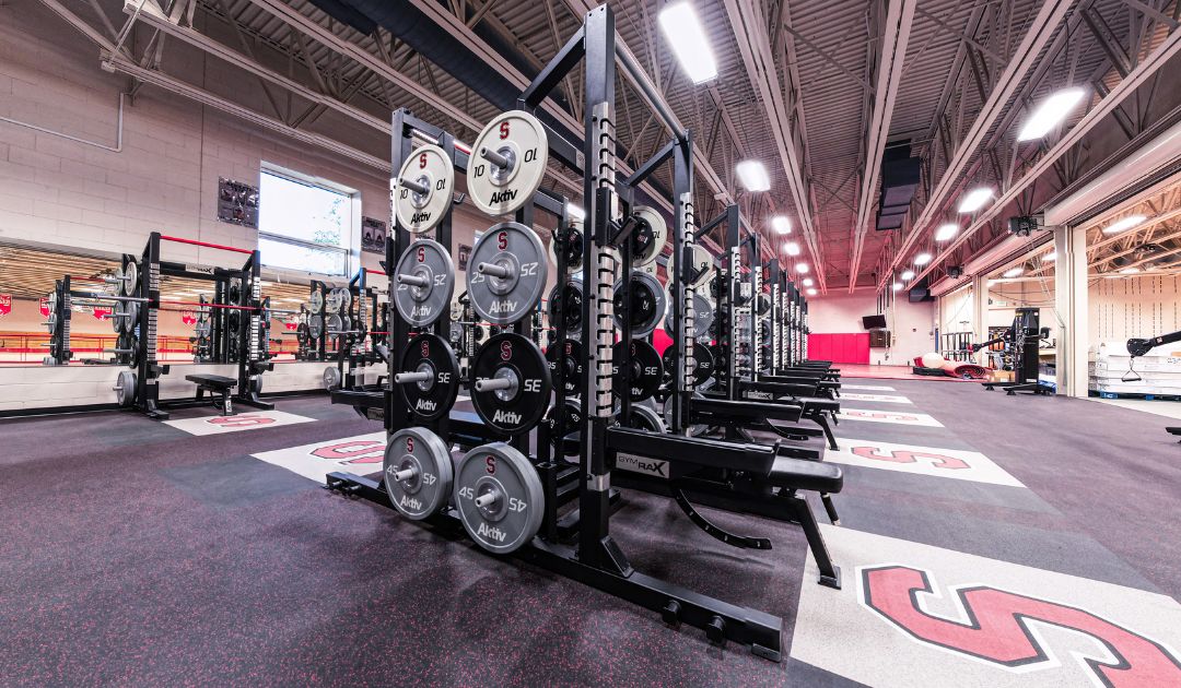 High school weight room gym designed with custom branded equipment.