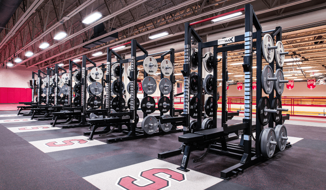 High school weight room with custom olympic racks and gym flooring